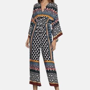 BCBG Maxazria jumpsuit with adjustable tie at the waist. Never worn, tags on.